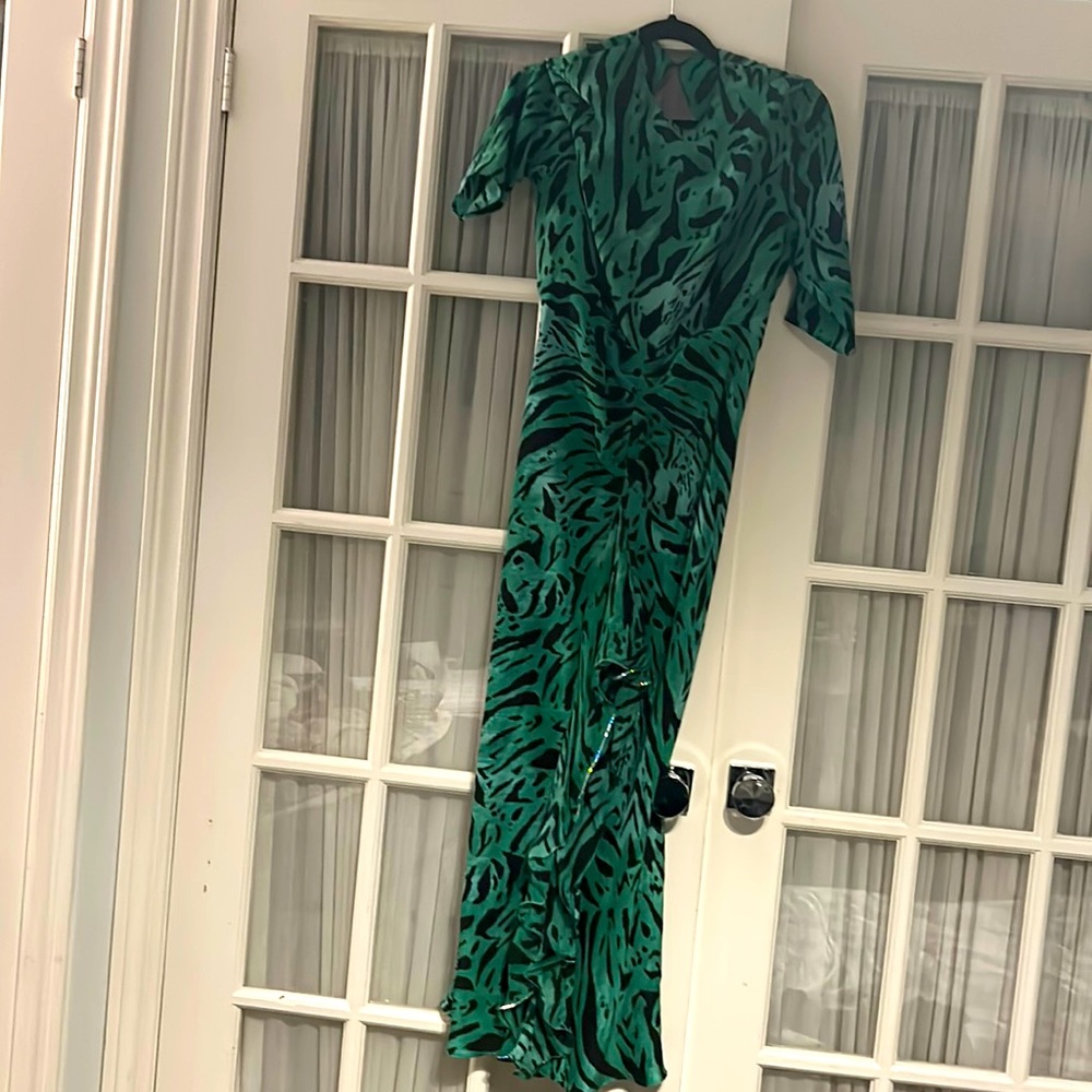 Green leopard print dress with opened back and frills.